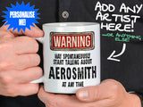 Aerosmith Mug held by man in black shirt – WARNING Design