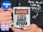 Audrey Hepburn Mug - held by man in black shirt – WARNING Design