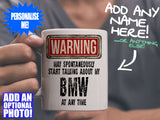 BMW Mug - held by man in grey v-neck tee – WARNING Design