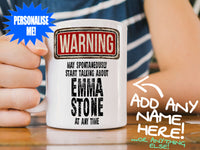 Emma Stone Mug – on wooden table with striped t-shirt
