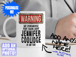 Jennifer Coolidge Mug – on desk with man writing on clipboard – WARNING Design