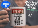 Jimi Hendrix Mug held by man in grey tee shirt – WARNING Design