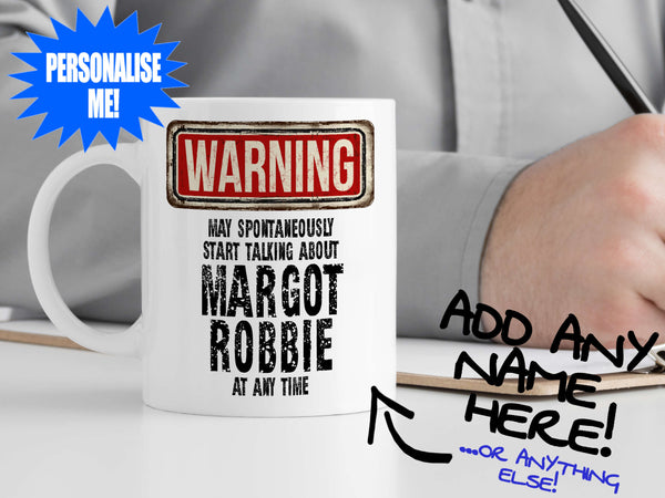 Margot Robbie Mug – on desk with man writing on clipboard – WARNING Design