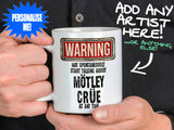 Mötley Crüe Mug held by man in black shirt – WARNING Design
