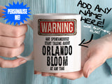 Orlando Bloom Mug - held by woman in turquoise blouse