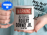 Robert Downey Jr Mug - held by woman in turquoise blouse - Shortcut