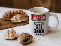Sean Connery Mug with coffee and pastries – WARNING Design
