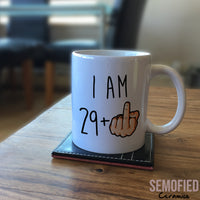 I am 29 + Middle Finger Mug - 30th Birthday Cup on Coffee Table