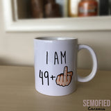 I am 49 + Middle Finger Mug - 50th Birthday Cup on Sideboard
