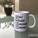 Eat Sleep Hockey Repeat Mug on Glass Table