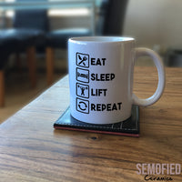 Eat Sleep Lift Repeat Mug on Coffee Table